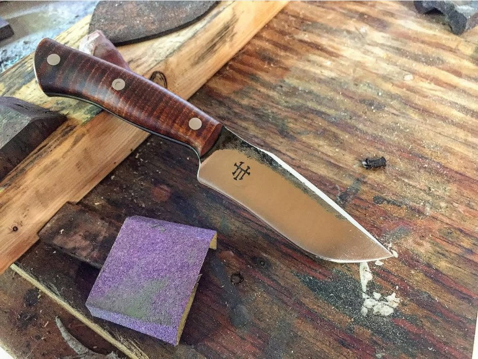 Full-tang knife with pinned wood scales and no metal bolster